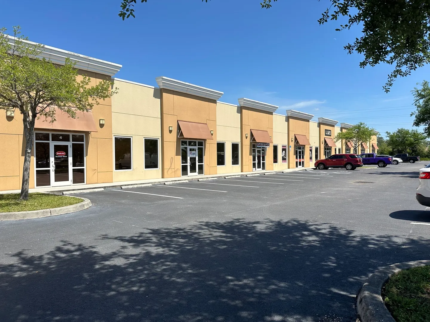 A parking lot with several stores on it.